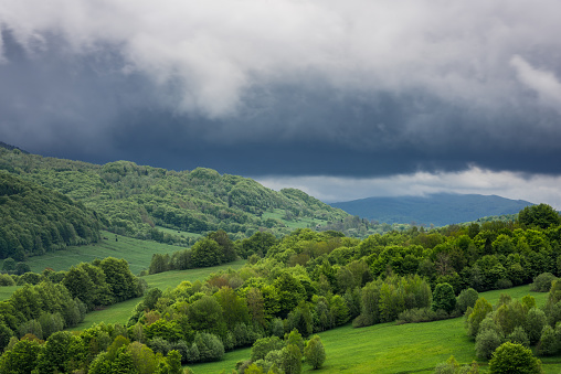 Dramatic stormy weather clouds over peaks in Bieszczady National Park, Poland.
