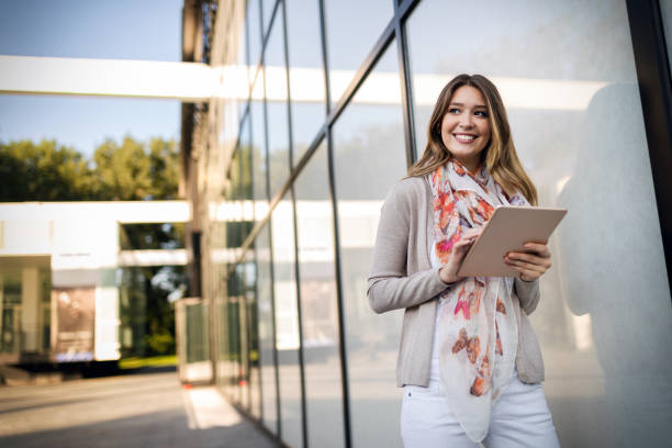 istock Beautiful brunette girl using tablet for work, freelance, blogging, studying, shopping 1157941048