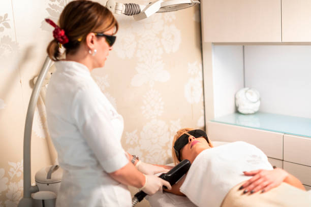 istock Using a laser for hair removal procedure in a cosmetic salon 1157942585