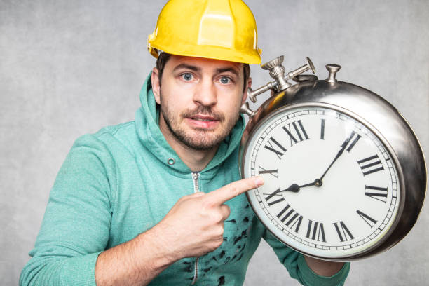 istock concept of time in matters of construction, builder and clock 1157945499