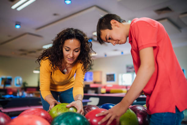 istock Boy bowling with his mother 1157947646