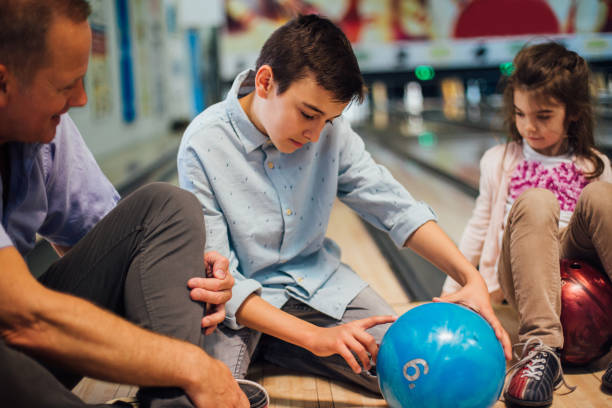 istock Boy choosing bowling ball with family 1157947647
