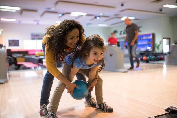 Mother and daughter bowling stock photo