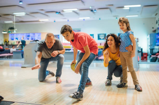 istock Family at bowling alley 1157947654
