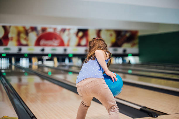 istock Young girl bowling 1157948373