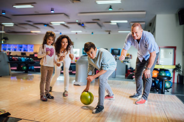 istock Boy bowling with family 1157948377