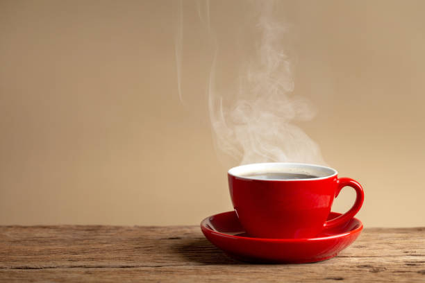 istock coffee cup on old wooden table with cream wall background. 1157949276