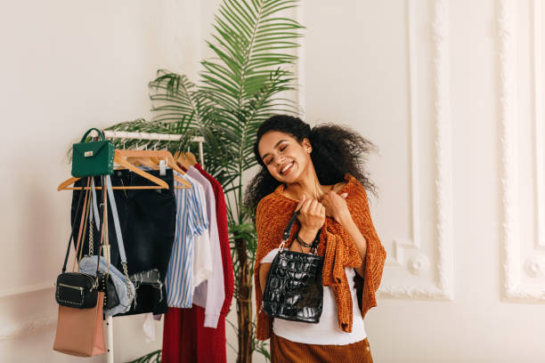 istock Smiling buyer with eyes closed standing at wardrobe 1157950616
