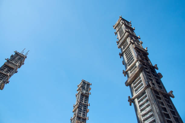 Traditional Chinese stone railing with intricate carvings under a clear blue sky with some clouds.