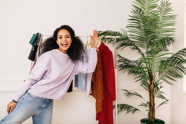 istock Happy stylist posing in studio. Young blogger greetings her audience. 1157950658