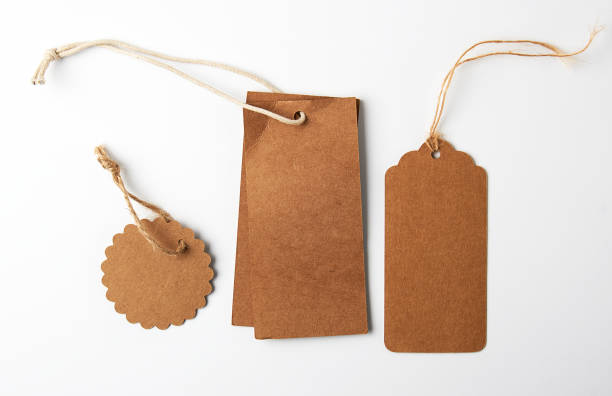 istock various brown paper tags with ropes on white background 1157950798
