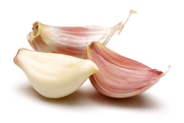 istock Garlic cloves isolated on white 1157952402