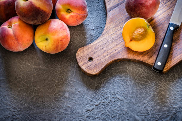 istock Whole and sliced peaches on dark gray textured background 1157954218