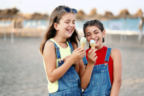 istock Two girls eating ice cream 1157954326