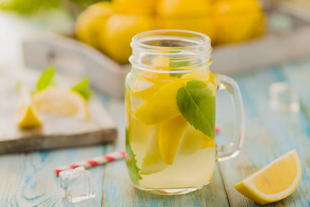 istock lemonade with mint on rocks served in jar with a straw 1157954443