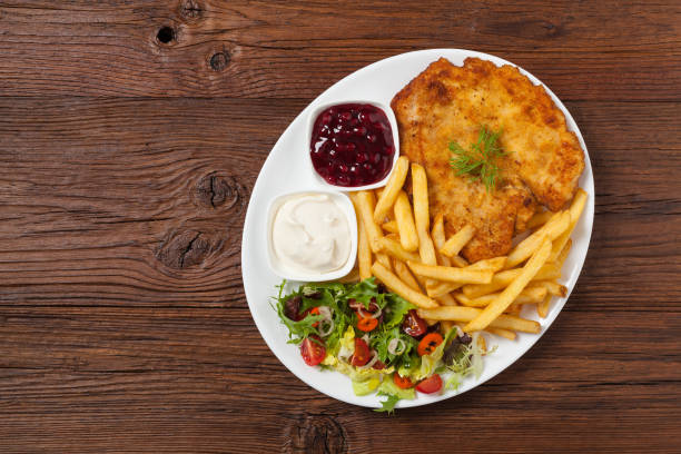 istock Chicken schnitzel, served with fries and salad. 1157954468