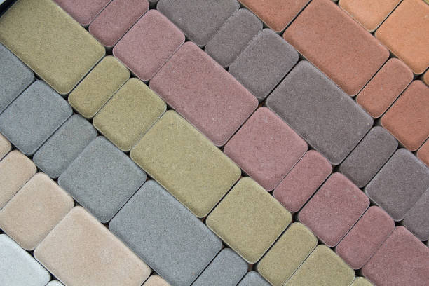 istock Multicolored paving slabs for road paving by mosaic on shop window. Construction 1157955825