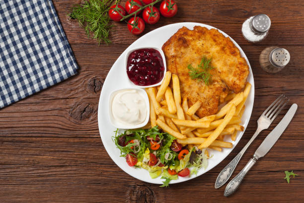 istock Chicken schnitzel, served with fries and salad. 1157956195
