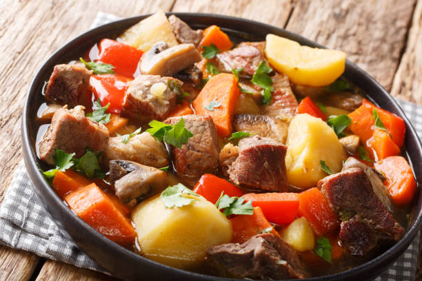 istock Pork gravy with mushrooms and vegetables close-up on a plate. horizontal 1157956247