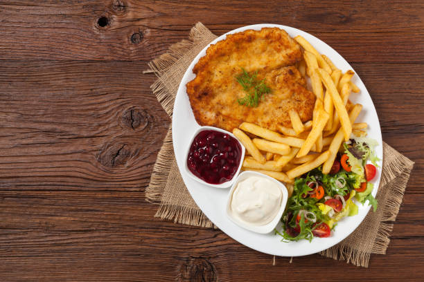 istock Chicken schnitzel, served with fries and salad. 1157956251