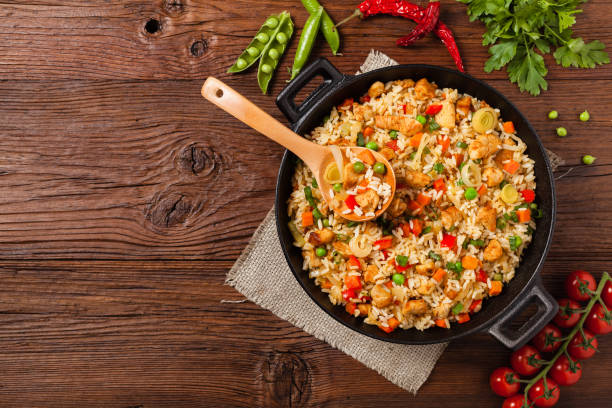 istock Fried rice with chicken. Prepared and served in a wok. 1157956279