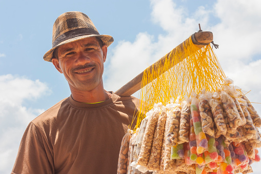 Recife, Pernambuco, Brazil - April 20, 2019: Brazilian man's portrait selling candies on the beach.