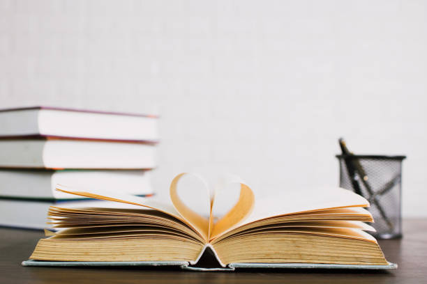 istock open book on desk, knowledge and education concept 1157957243
