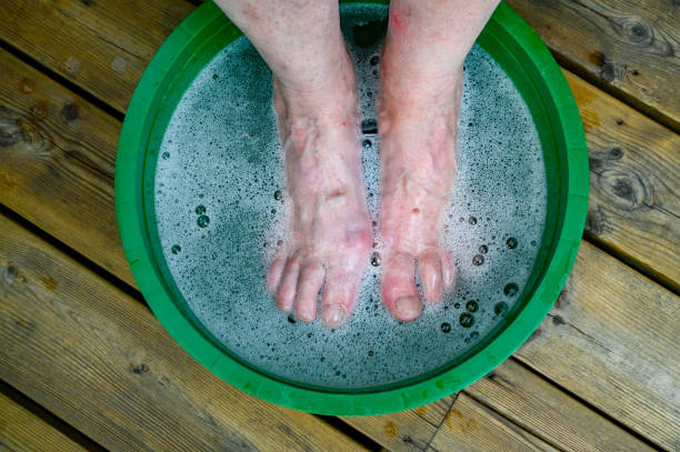 Tanned legs of a child in the pool water