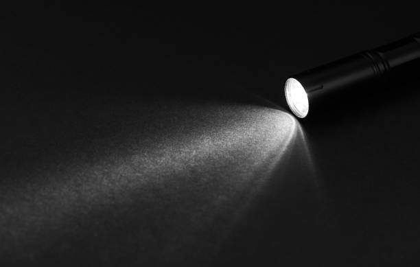 Flashlight and beam of light on a dark background Flashlight and beam of light on a dark background searchlight photos stock pictures, royalty-free photos & images