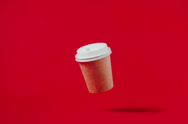 istock Paper coffee Cup isolated on red background 1157957915