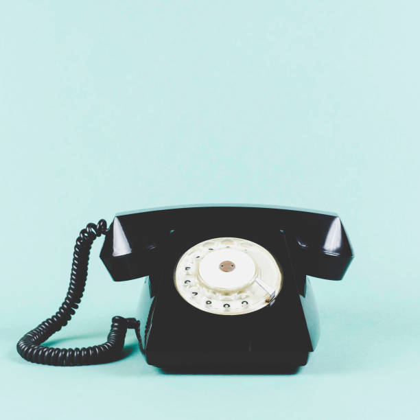 istock Old phone on green background 1157957926