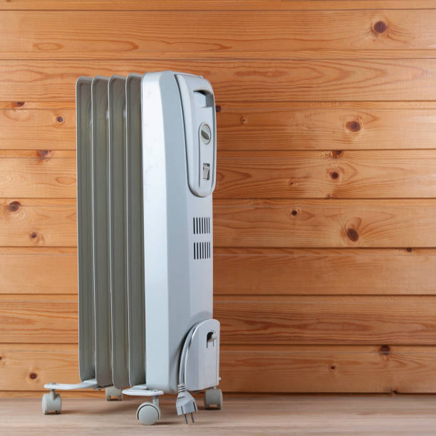 istock Heater against a wooden wall. Space for text or design 1157957979