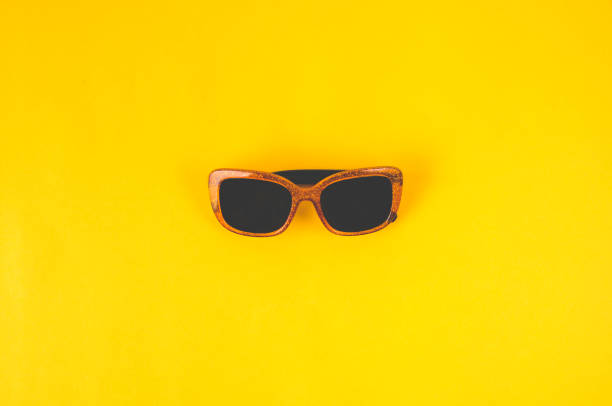 istock Women's sunglasses on yellow background 1157957985