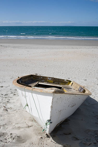 istock Painted Wooden Boat on Isolated Beach 115795806