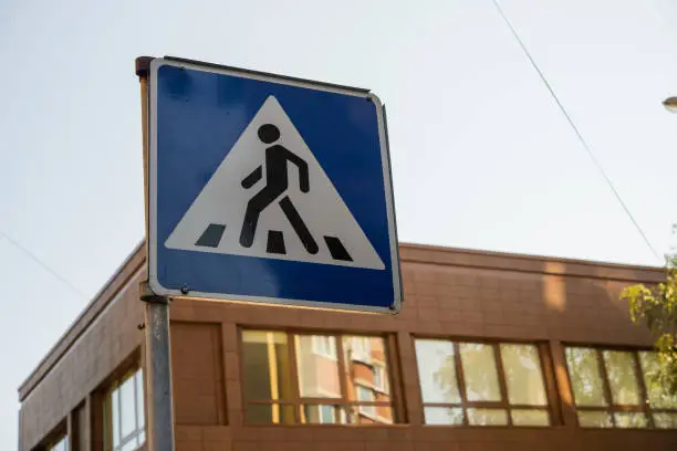 Photo of pedestrian sign on the background of the building