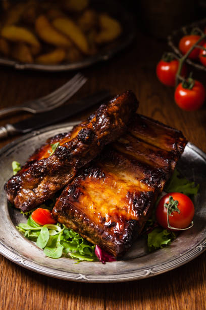 istock Roasted ribs, served on an old plate. Dark or balck background. 1157960330
