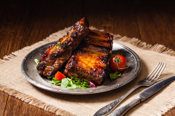 istock Roasted ribs, served on an old plate. Dark or balck background. 1157960820