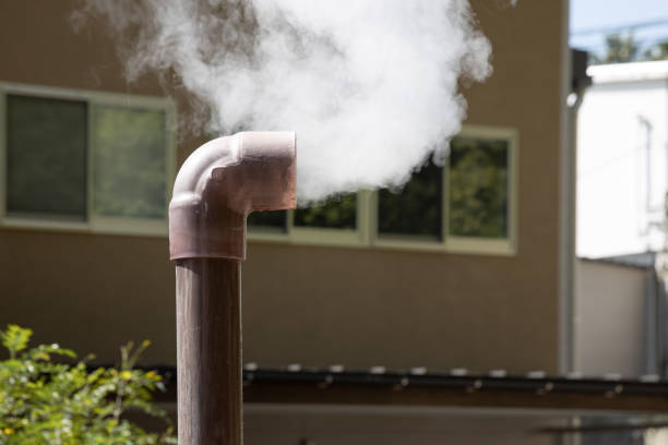 clean steam form smoking small bronze pipe at outdoor hot springs.