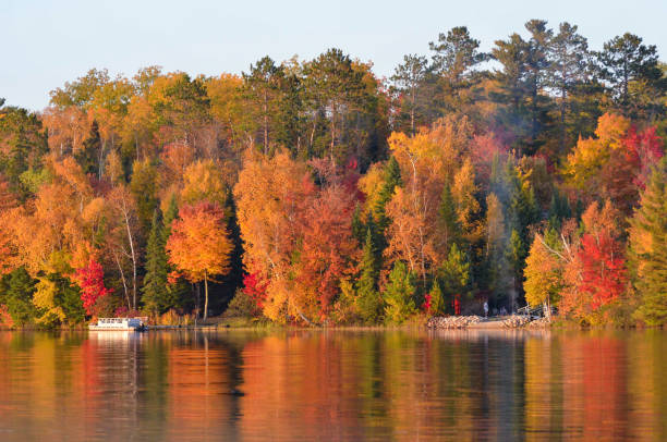 istock Extreme fall colors reflecting in lake water 1157965109