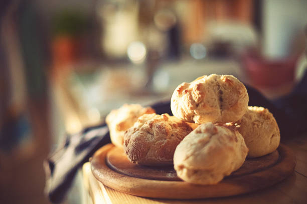 fresh home-baked wheat rolls are ready for breakfast in the morning light stock photo