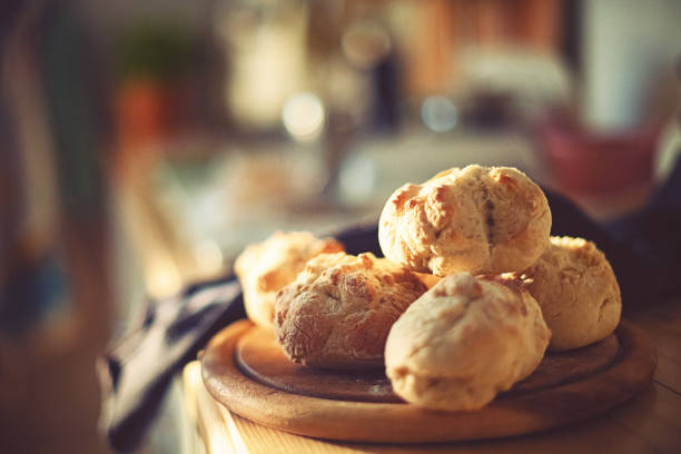 fresh home-baked wheat rolls are ready for breakfast in the morning light fresh home-baked wheat rolls are ready for breakfast in the morning sun bun stock pictures, royalty-free photos & images