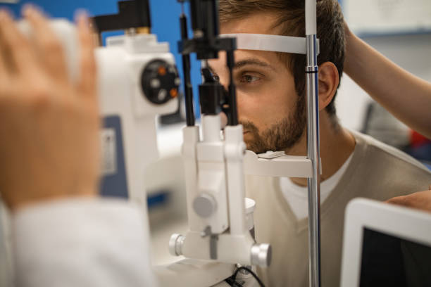 istock Young man having his eyes examined by optometrist 1157971263