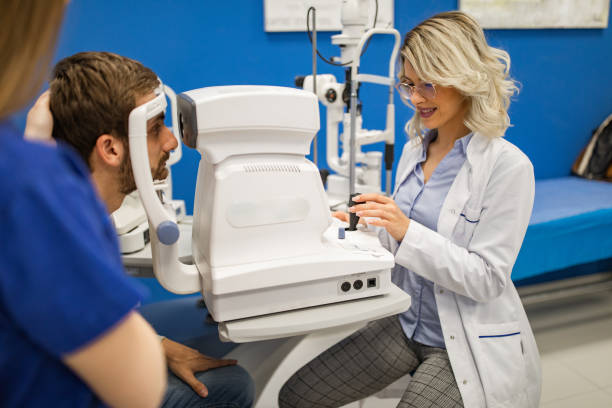 istock Young man having his eyes examined by optometrist 1157972041