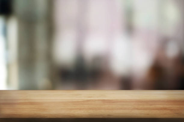 istock empty wood table with blur montage coffee shop or restaurant background. 1157972064