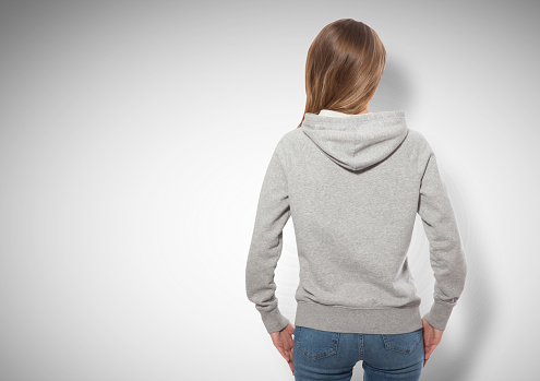 young girl in gray sweatshirt, gray hoodies back view isolated on white background. mock up
