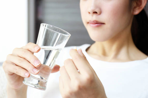 istock Woman taking medicine 1157974065