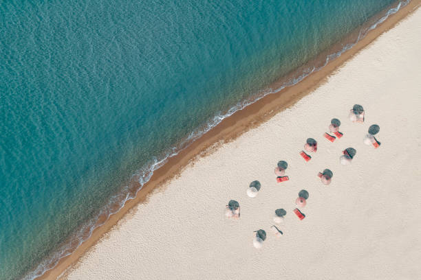 istock peaceful aerial beach with sunshades 1157974235