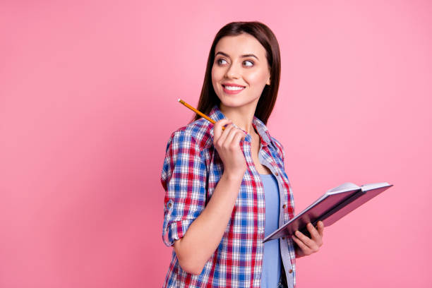 istock Close up side profile photo beautiful amazing she her lady wondered look side empty space planner pen hands arms pensive ponder wear casual checkered plaid shirt clothes isolated pink background 1157976107