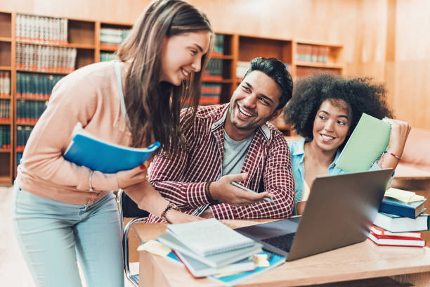 istock Multi-ethnic group of young people in the library 1157977566