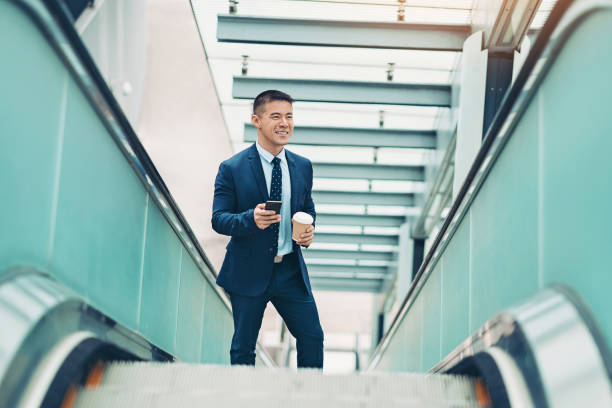 istock Businessman on an escalator 1157977578